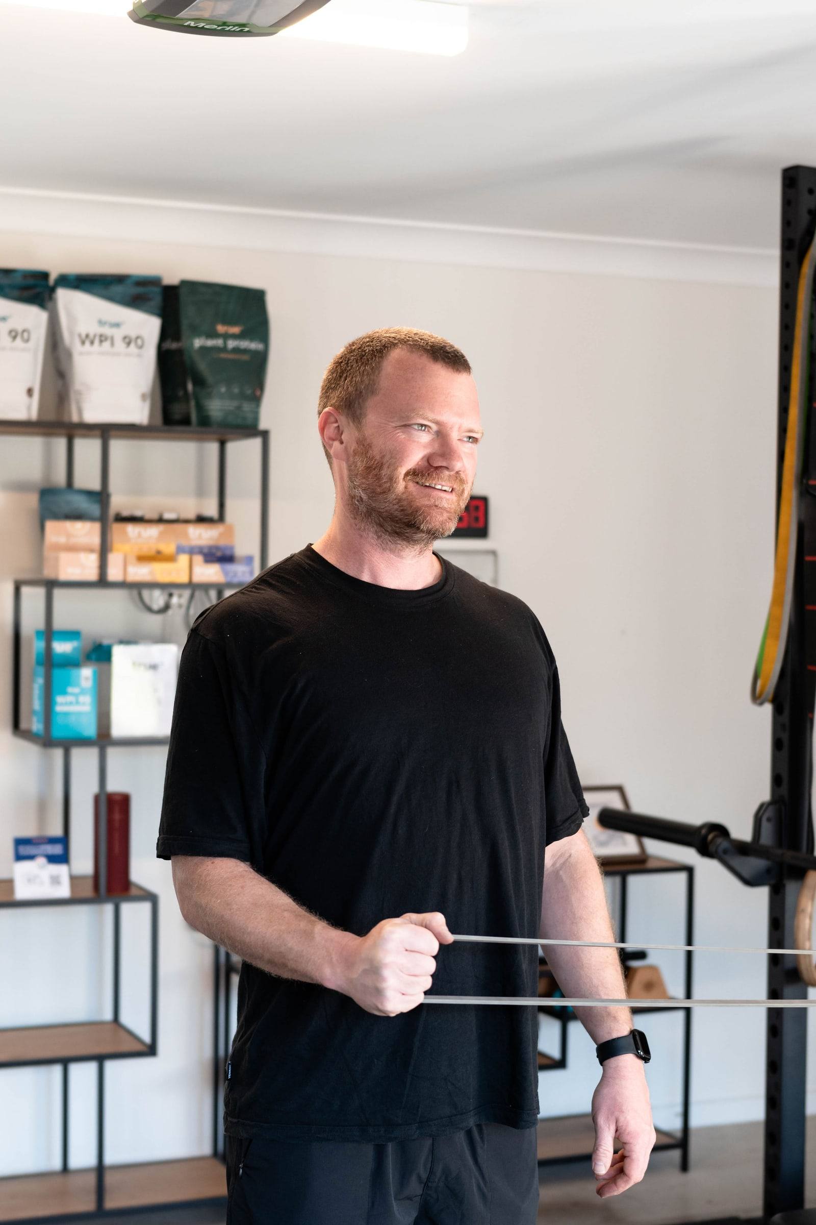 A client smiling during a resistance band exercise